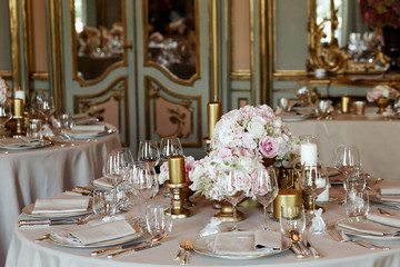 Wall Mural - Round dinner tables decorated with golden candleholders and vase