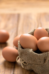 Wall Mural - Eggs in sack on wood table