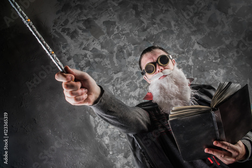 Cuadros en Lienzo evil wizard Merlin conjures and casts a spell, raising his wand, a young man dre