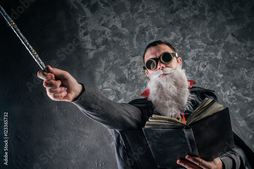Cuadros en Lienzo evil wizard Merlin conjures and casts a spell, raising his wand, a young man dre