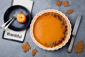 Wall Mural - Pumpkin pie, tart in a baking dish. Top view