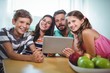 © WavebreakMediaMicro - Portrait of smiling family using digital tablet