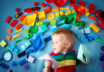 Wall Mural - Baby boy lying on the blanket with many toys around