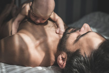 Newborn Baby Lying On Father Body In Bed