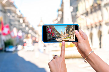 Canvas Print - Photographing with smart phone a street view in the center of the old town of Bern city in Switzerland