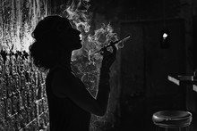 The Silhouette Of A Woman Smoking Black And White