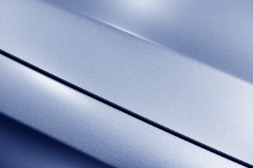 surface of blue sport sedan car metal hood, part of vehicle bodywork, steel gradient line pattern, s
