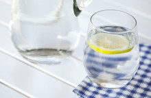 Glass Of Water With Lemon On White Background