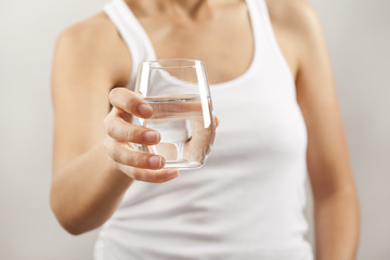 Wall Mural - Young woman drinking  glass of water