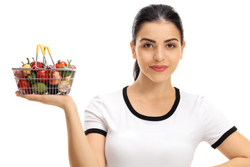 Poster - Young woman holding a small shopping basket