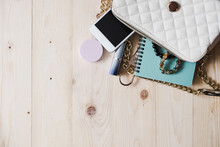 Top View Of Women Bag And Lady Stuff With Copyspace On Wooden Background