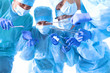 © lenetsnikolai - Team of surgeon in uniform perform operation on a patient at cardiac surgery clinic