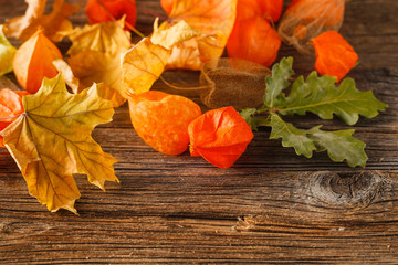 Canvas Print - Autumn leaves on wooden table. Autumn vintage background. Red an