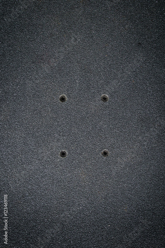 Fotografija  top view of a skateboard and griptape in skatepark