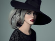 © AndrewLili - Portrait of young woman wearing hat and headscarf