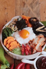 Wall Mural - Bibimbap korean food is delicious on wood background.