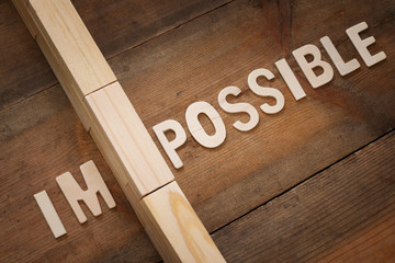 Poster - wall between of the letters IM from the word impossible