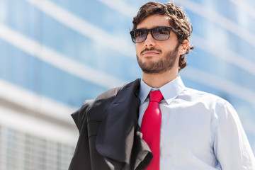 Wall Mural - Portrait of an handsome businessman in an urban setting