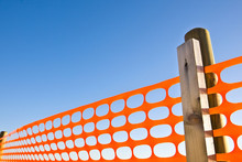 Construction Site With Safety Orange Grid Against A Blue Sky