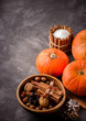  Fall harvest concept.Pumpkins, spices and nuts in wooden bowl.