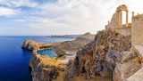 Greece. Rhodes. Acropolis of Lindos. Doric columns  the ancient Temple  Athena Lindia the IV century BC and the bay  St. Paul