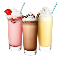 Poster - Glasses with delicious milk shakes on white background.