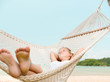 girl slipping in hammock on the beach