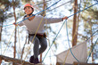 Happy enthusiastic woman having great time in the adventure park