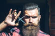 © Volodymyr - Man hipster with scissors