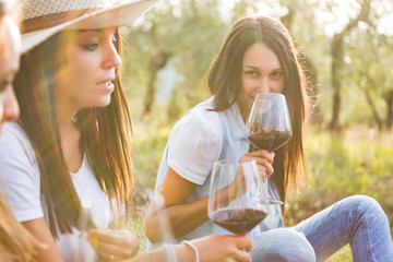 Young friends drinking red wine