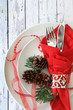 Christmas table place setting on white wood background