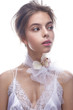 © iulskaya_photo - Beautiful girl in image of bride with flower orchid on her neck. Model with nude makeup and silk underwear. Beauty face. Photo was taken in a studio.