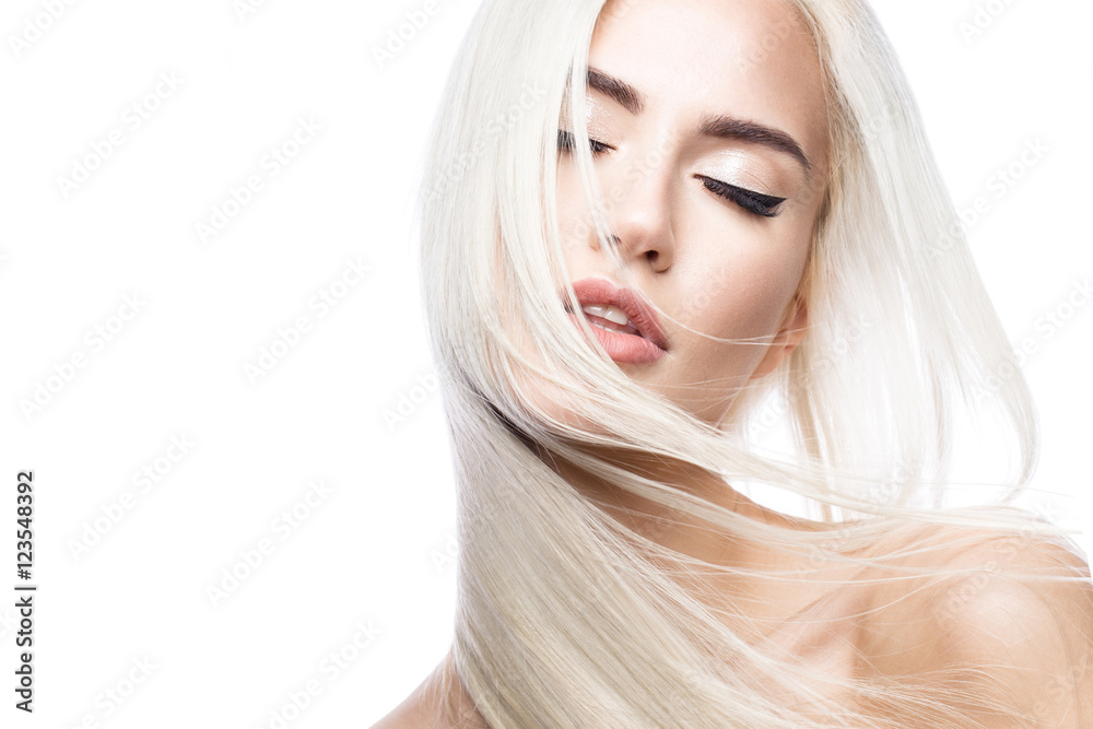 Beautiful blond girl in move with a perfectly smooth hair, and classic make-up. Beauty face. Picture taken in the studio. - obrazy, fototapety, plakaty 