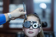 © Westend61 - Girl doing eye test at optometrist's