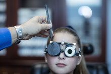 Girl Doing Eye Test At Optometrist's