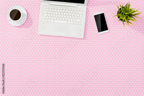 Pink Office Desktop With White Laptop Smart Phone And Coffee Cup