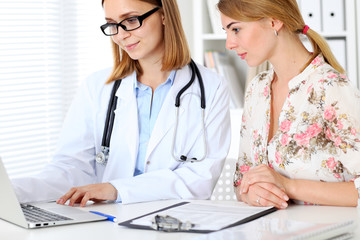 Doctor and  patient  sitting at the desk