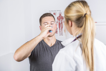 Wall Mural - Medical doctor applying oxygen treatment on a sporty men