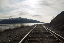 Railroad Tracks By Sea Against Sky