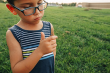 Boy Looking At Moth Sitting On Finger At Park