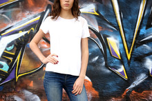 Young Woman In Blank T-shirt Against Graffiti Wall, Closeup