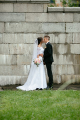 Wall Mural - Wedding. Charming bride and elegant groom enjoying romantic moments on their wedding day.