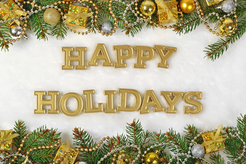 Happy holidays golden text and spruce branch and Christmas decor