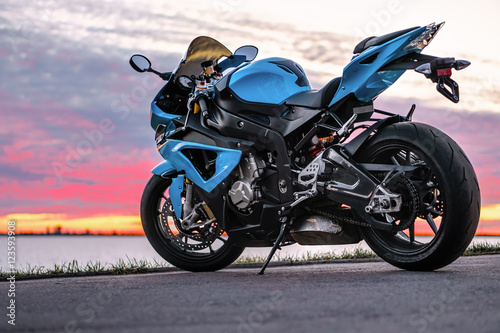 Sports motorcycle on the shore at sunset Wallpaper Mural