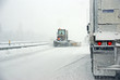 Snowplow and trucks during snowstorm