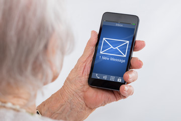 Wall Mural - Senior Woman Checking Message On Smartphone