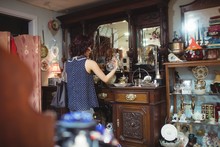 Rear View Of Woman Shopping For Antiques