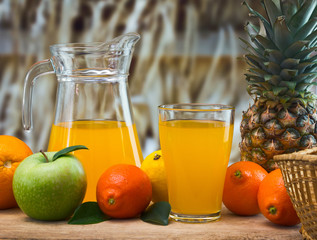 Wall Mural - orange juice in a glass on a table