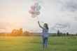 © sunti - Back of happy beautiful young woman standing holding colorful of