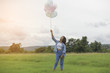 © sunti - Happy beautiful young woman standing holding colorful of balloon